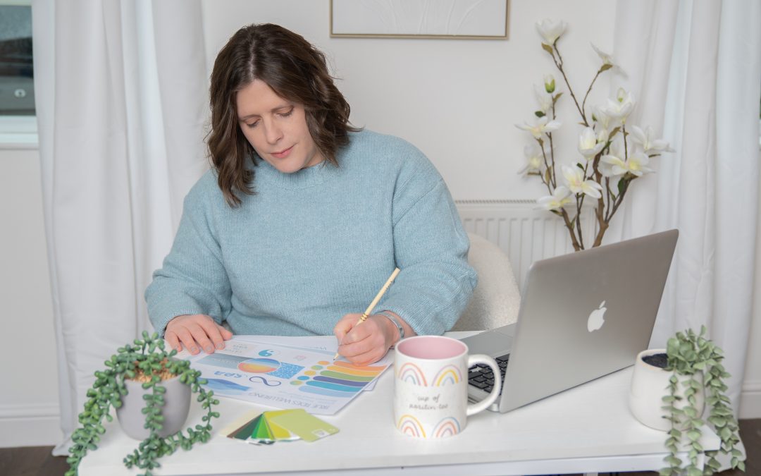 Lady 40+ sat at desk working on graphic design